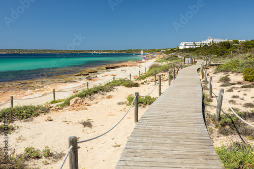 Wooden walking path along the Migjorn beach, Formentera island. Spain. photo