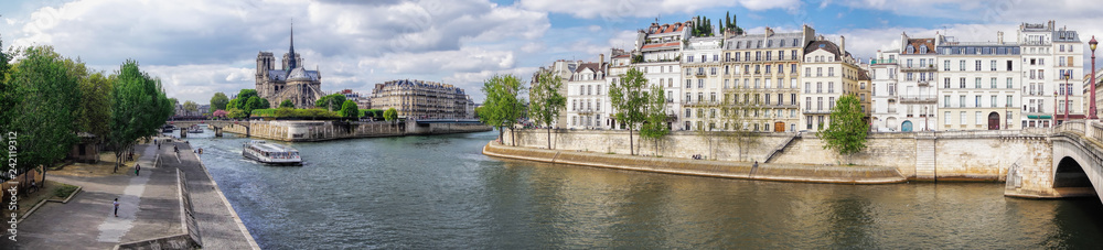 Panorama with Notre Dame cathedral and boat on Seine in Paris, France