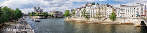 Panorama with Notre Dame cathedral and boat on Seine in Paris, France