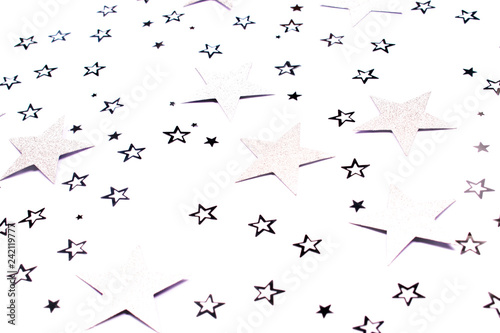 Silver star confetti on white background.