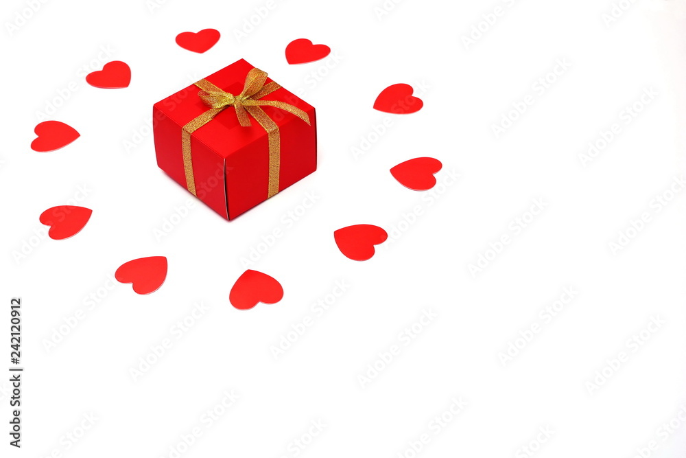 Red box with a bow of Golden ribbon. Gift and Hearts of red paper. Holiday and love concept. Valentine's day Red box with a bow of Golden ribbon. Gift and Hearts of red paper. Holiday and love concept. Valentine's day
