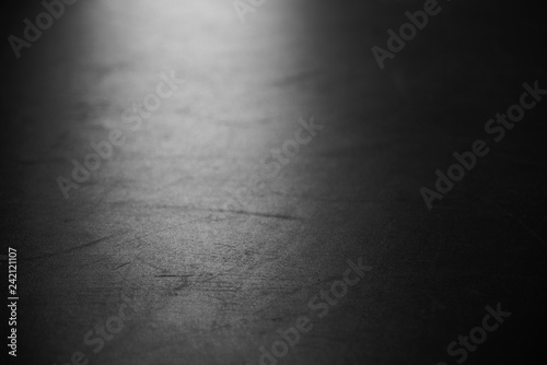 Black ballet hall floor on blue spotlight.Background for dance and theater.
