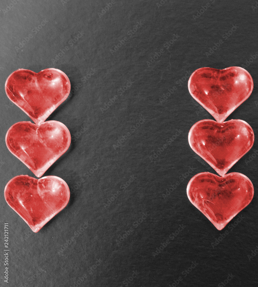 Obraz premium Red hearts on a black background.