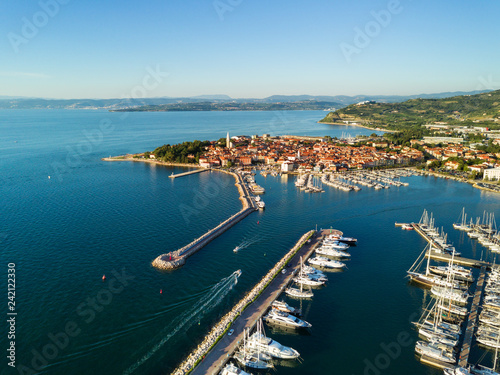 Aerial view of old fishing town Izola in Slovenia, cityscape with marina at sunset. Adriatic sea coast, peninsula of Istria, Europe.