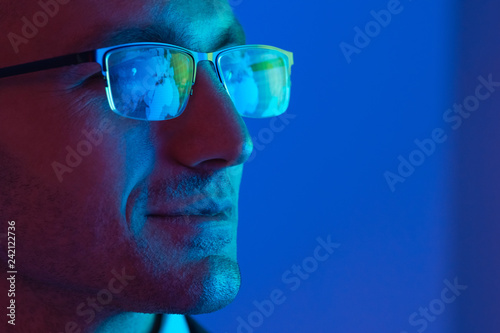 The portrait of the happy businessman in glasses