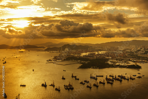 Cargo port and harbor in Hong Kong city under sunset