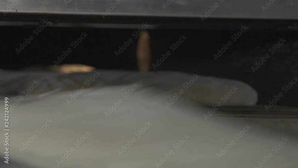 Bakers load bread dough into oven Bakers load bread dough into oven