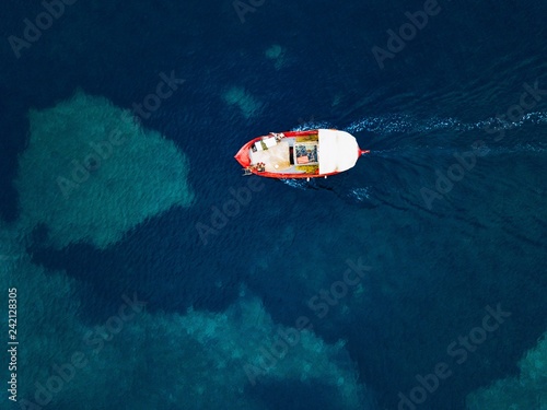 Aerial view of small fishing boat at sea, Greece.