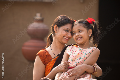 portrait of loving Indian mother and daughter at village