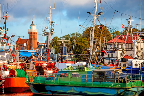 Fishing port of Ustka, Poland with old lighthouse photo