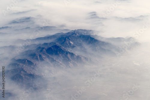 Aerial landscape mountain lost in thick fog in China, bird eye view landscape look like a painting style of chinese © kardd