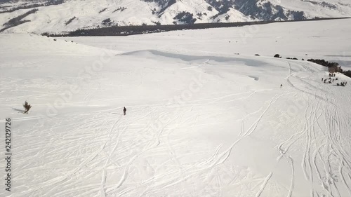 aerial survey free ride snowboard a group of snowboarders down the slope photo