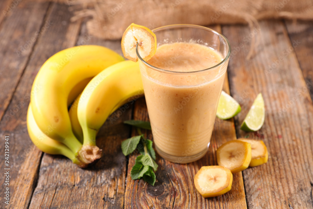 banana smoothie on wood background