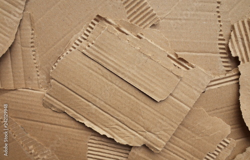 Pieces of torn cardboard paper packaging laid out flat and photographed as a background