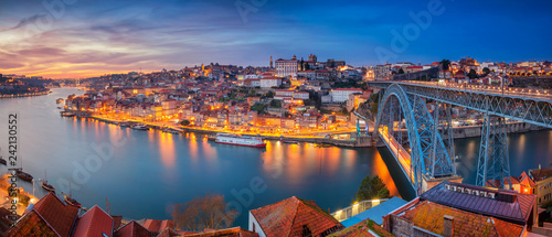 Porto, Portugal. Panoramic cityscape image of Porto, Portugal with the famous Luis I Bridge and the Douro River during dramatic sunset. photo