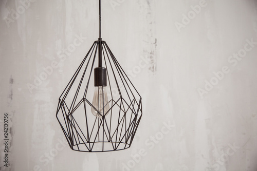 decorative chandelier on a white wall background. Chandelier Lighting. Light Fixture with LED Bulbs. © Anna-Tsygankova