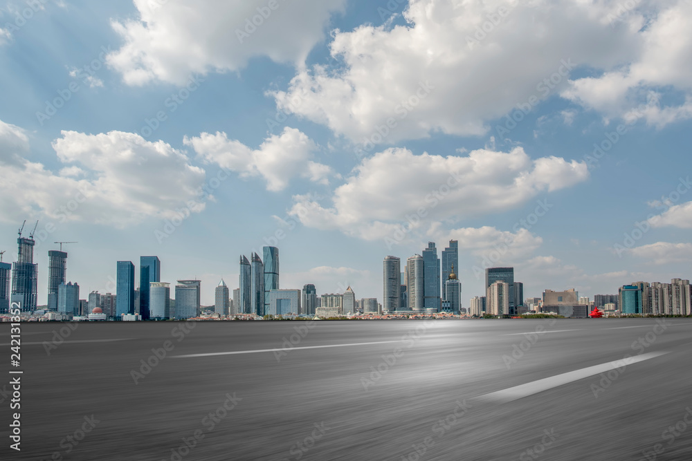 Empty asphalt road along modern commercial buildings in China,s cities Empty asphalt road along modern commercial buildings in China,s cities