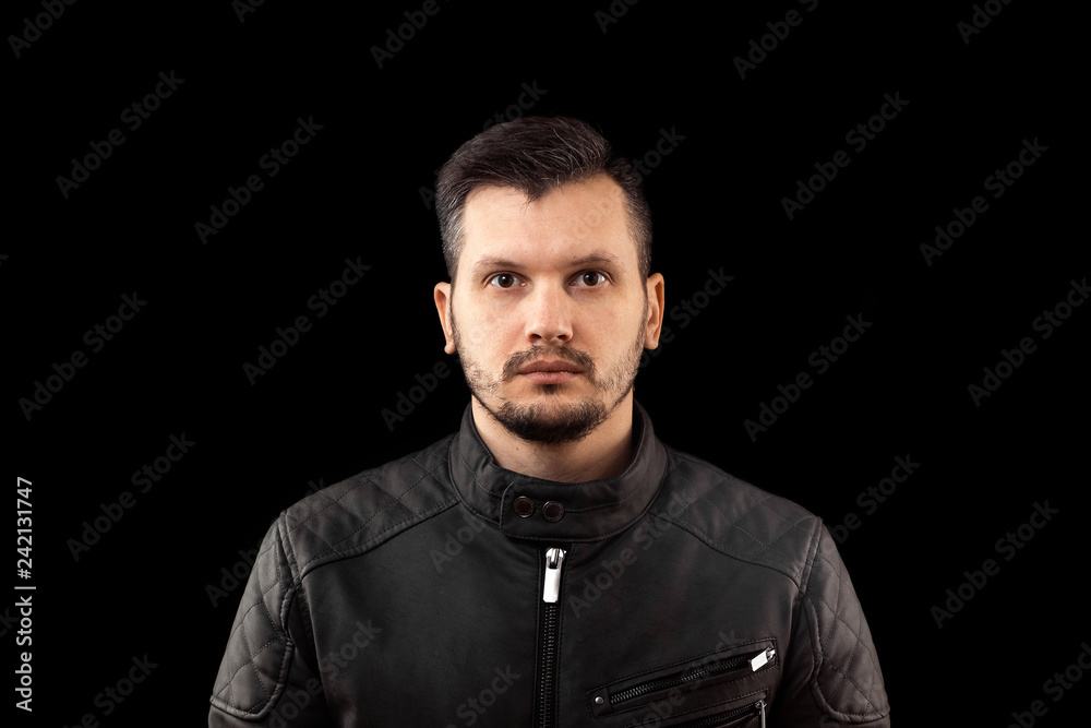 young man close up portrait, on black background young man close up portrait, on black background