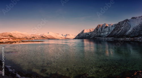 Beautiful winter sunset landscape, panorama of the lake with snowy mountains with blue sky, natural travel outdoor background, Lofoten Islands, Northern Norway © larauhryn