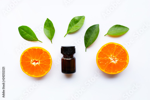 Orange essential oil with fresh fruits on white background