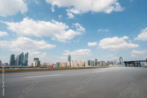 Empty asphalt road along modern commercial buildings in China s cities