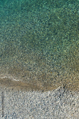 Top view aerial photo of sea waves with turquoise water from unmanned flying.