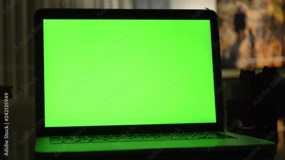 Laptop with green screen. Dark home office . Dolly shot of Perfect to put your own image or video. Laptop with green screen. Dark home office . Dolly shot of Perfect to put your own image or video.