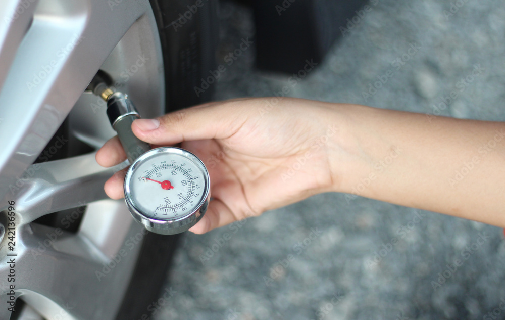 Fototapeta premium Check the tire pressure of the car