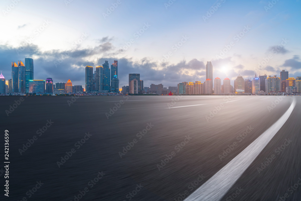 Empty asphalt road along modern commercial buildings in China,s cities Empty asphalt road along modern commercial buildings in China,s cities
