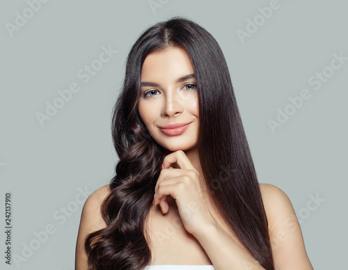 Young beautiful woman with straight and curly hairstyle. Hair styling and hair care concept. Young brunette woman