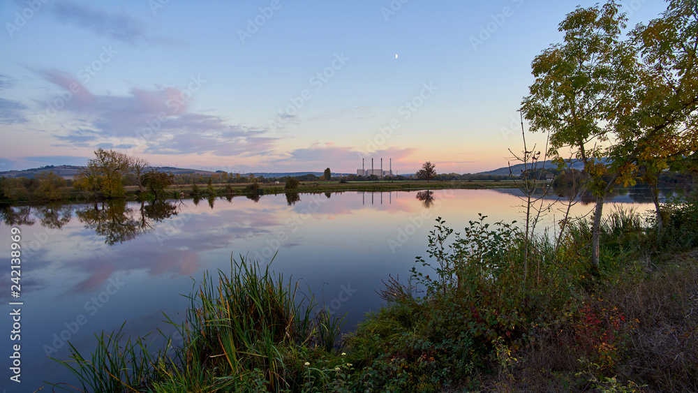 Panoramic View Of A Lake At Sunset With A Coal Power Station In