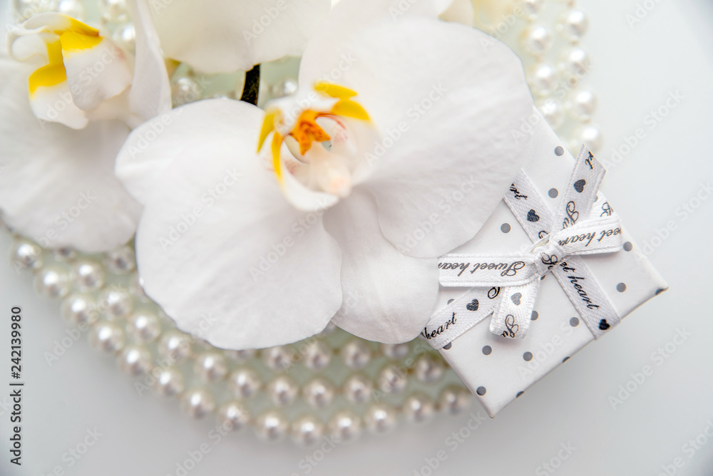 Gift box and white orchid on a white background Gift box and white orchid on a white background