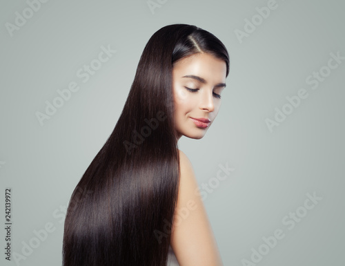 Brunette woman with long healthy shiny straight hair, fashion portrait