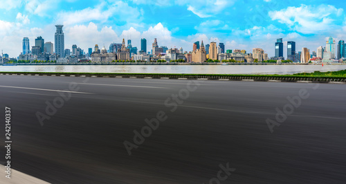 Empty asphalt road along modern commercial buildings in China s cities