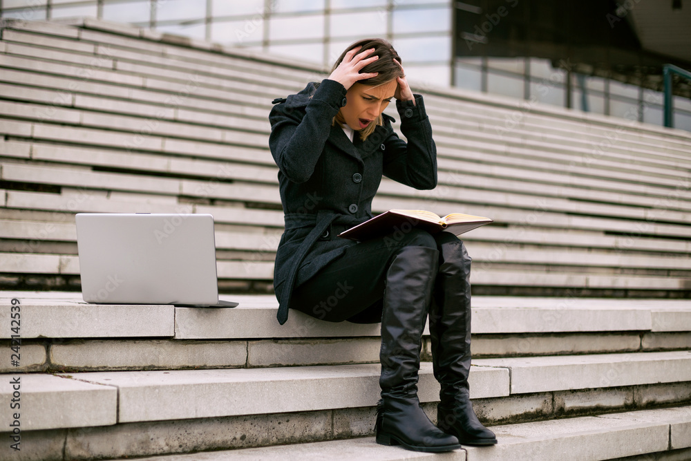 Businesswoman in panic while working outdoor.