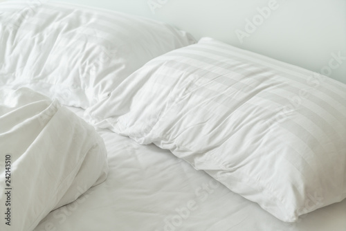 pillow on bed and with wrinkle messy blanket in bedroom