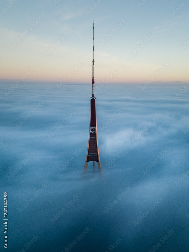 The Riga Radio and TV Tower in Riga, Latvia is the tallest tower in the  European Union. Tip sticking out of fog layer during beautiful sunrise.  Stock Photo | Adobe Stock