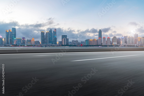 Empty asphalt road along modern commercial buildings in China s cities