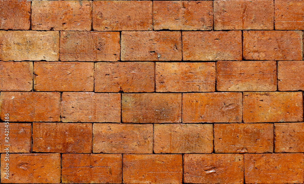 Obraz premium raw rough brown brick stack wall texture background.
