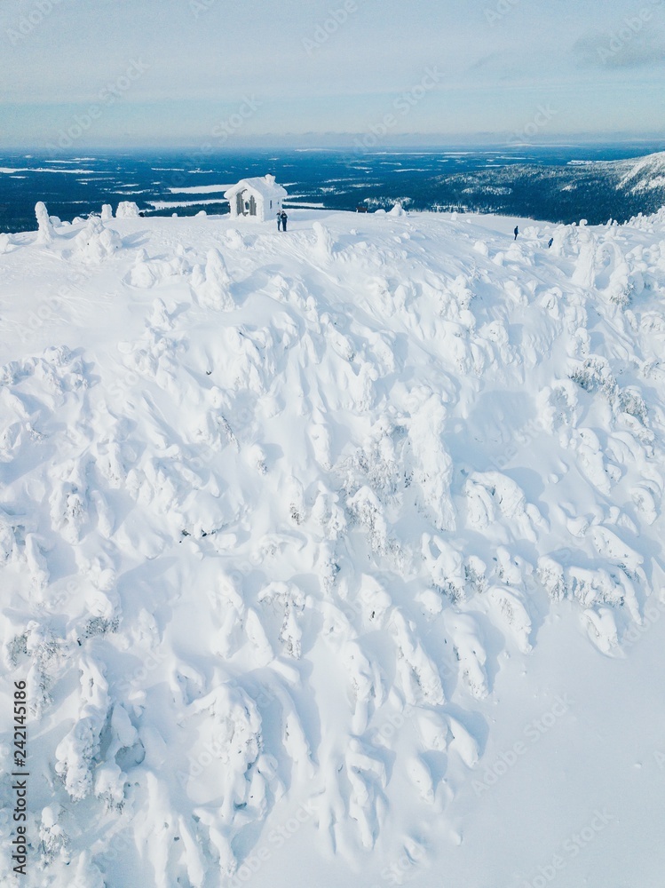Aerial view of winter snow covered wood hut. Frozen log cabin in Finland Aerial view of winter snow covered wood hut. Frozen log cabin in Finland