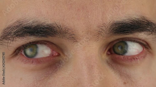 man eyes moves from side to side, reading from upper to center, close-up