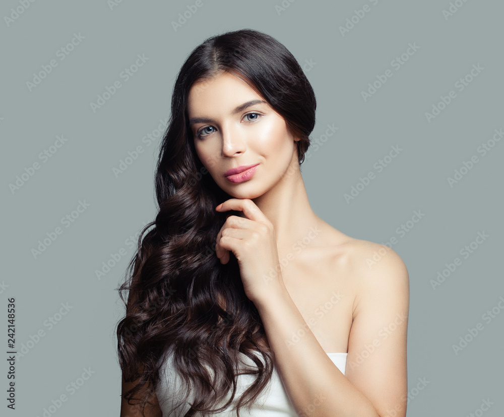 Young woman thinking. Girl with long curly hair portrait Young woman thinking. Girl with long curly hair portrait