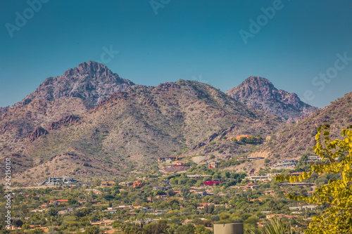 Neighborhoods at the base of tall mountains are rapidly growing in the Phoenix, Arizona area where population is steadily growing. Housing in these mountain base developments are usually more expensiv photo