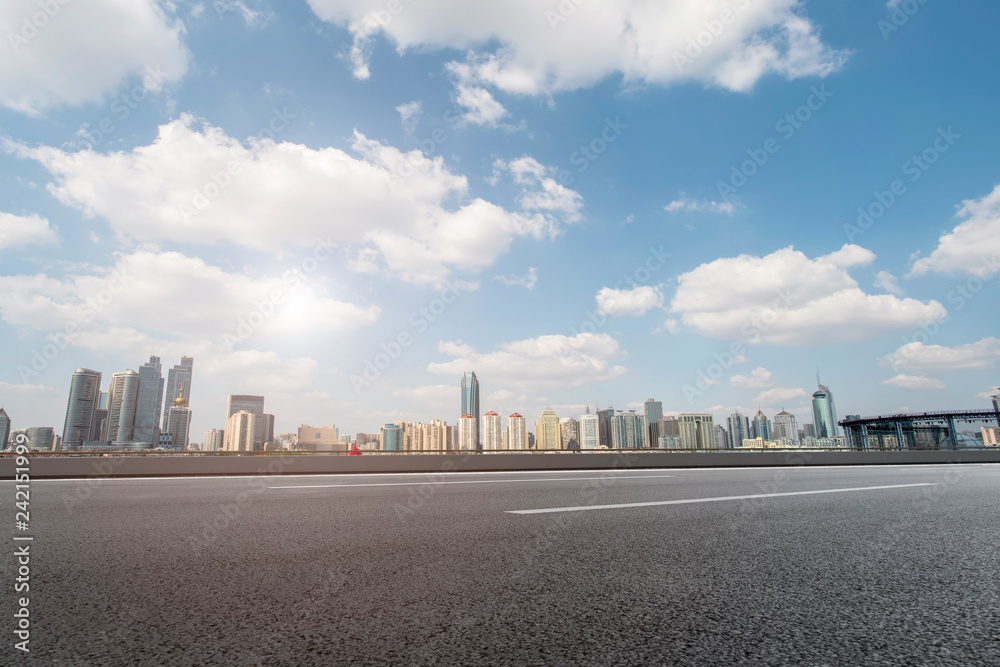Empty asphalt road along modern commercial buildings in China,s cities Empty asphalt road along modern commercial buildings in China,s cities