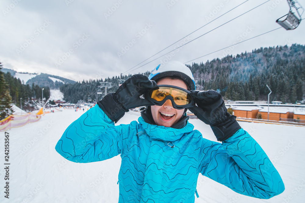 portrait of young smiling woman in ski equipment. winter sport activity