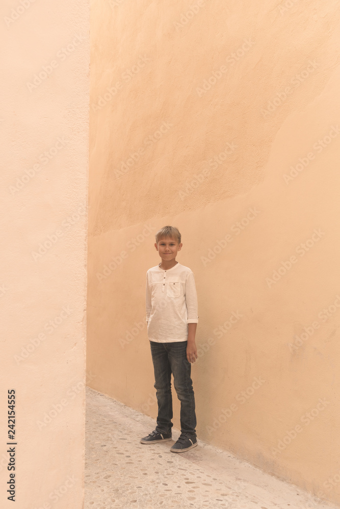 Smiling boy standing in the street outdoor Smiling boy standing in the street outdoor