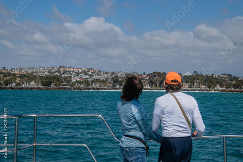 Older couple looking at water and coastline © ALAN