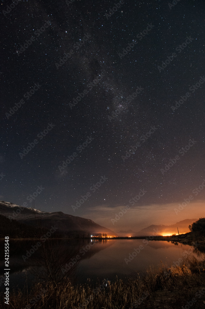 night photography with reflection of the stars in the lake