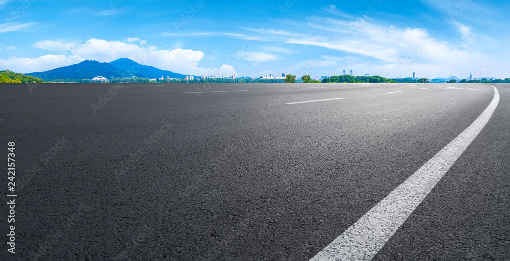 Fototapeta premium Empty asphalt road square and natural landscape under the blue sky