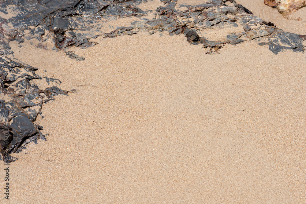 Obraz premium stone, rocks frame on beach sand background.